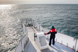 Scientists look for right whales during a research cruise