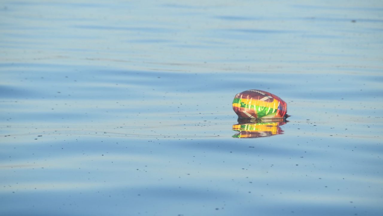 balloon floating on top of open water