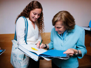 Sylvia Earle signs her book for an attendee at the Aquarium's Lowell Lecture Series