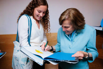 Sylvia Earle signs her book for an attendee at the Aquarium's Lowell Lecture Series