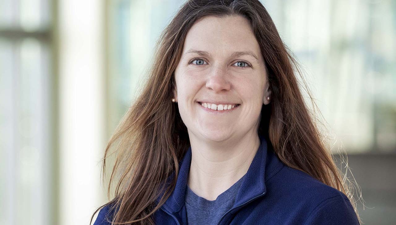 A headshot of Patty in the Marine Mammal Center, wearing a blue Aquarium fleece